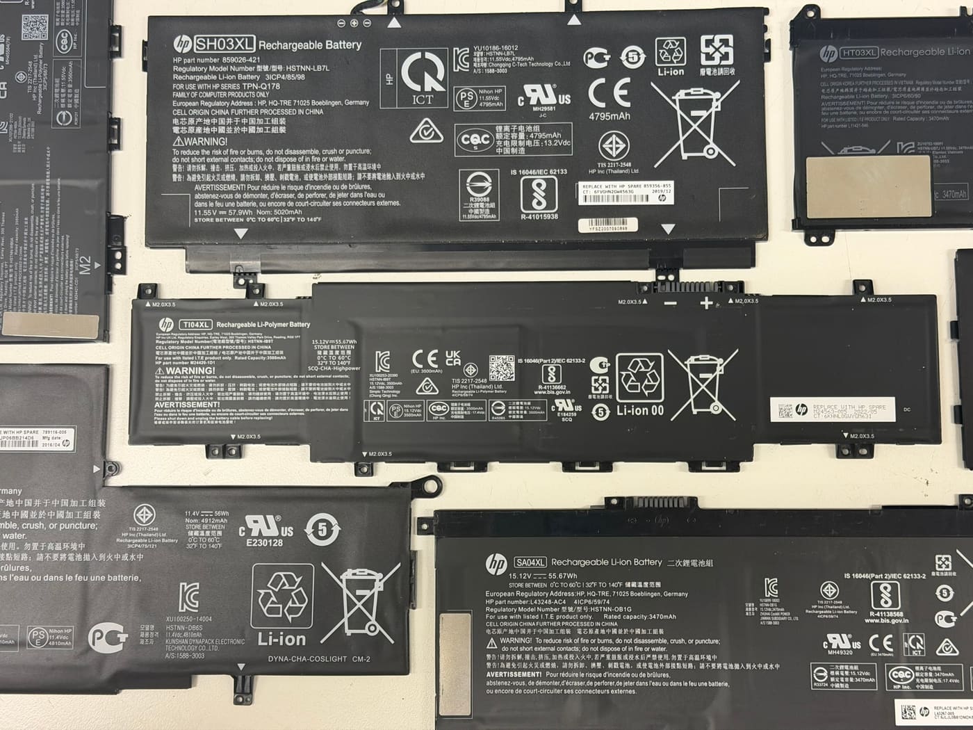 Genuine HP replacement batteries — SH03XL, TI04XL and SA04XL — in our Perth workshop